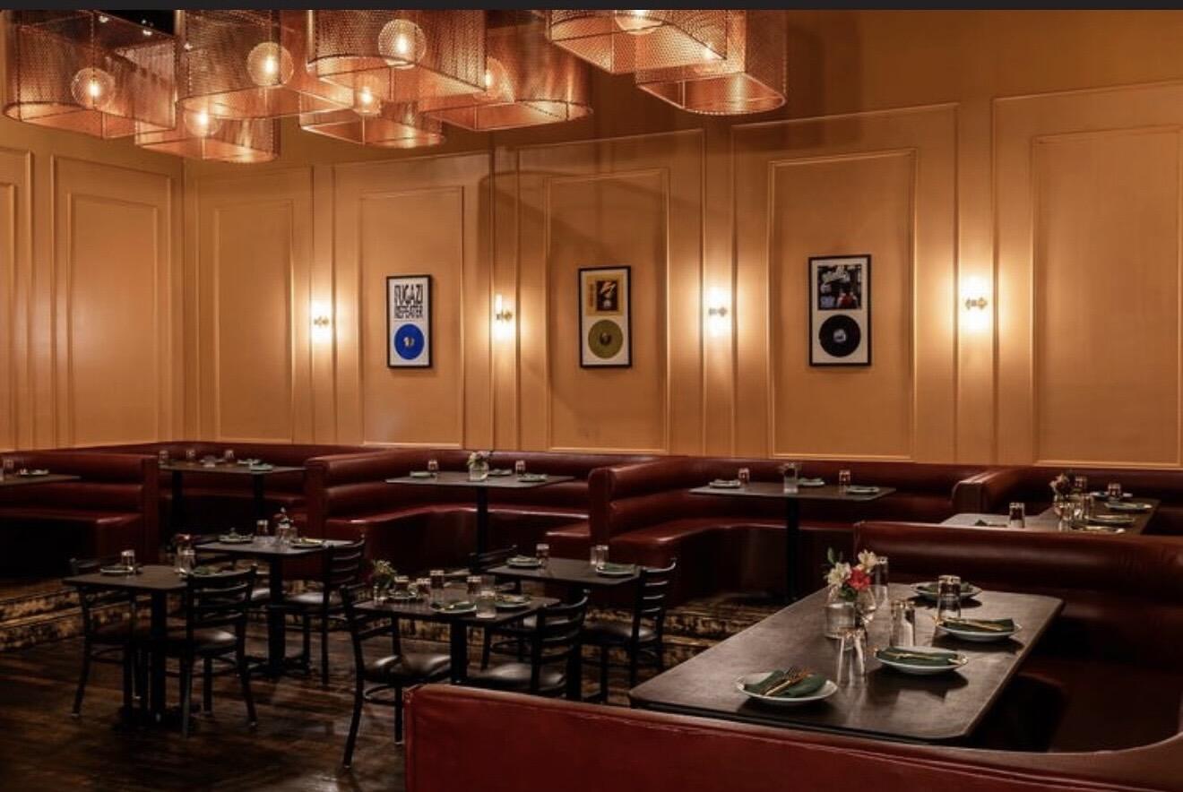 Fraiche DC restaurant interior with gold walls, burgundy booths, and copper lighting in Columbia Heights Washington DC